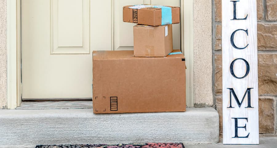 Deliveries on the front porch of a house with a welcome sign in Baltimore